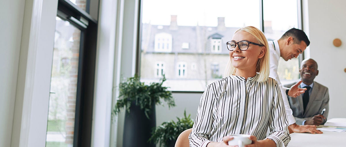 Smiling young businesswoman enjoying her coffee during an office break, Smiling young businesswoman enjoying her coffee during an office