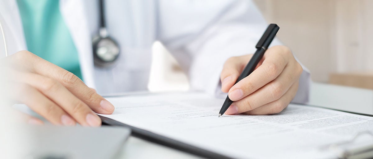 Asian woman Doctor with green cloth and lab coat working and taking note information of patient in checklist paper on clipboard in medical room of hospital. Health care, Asian woman Doctor with green cloth and lab coat working and tak